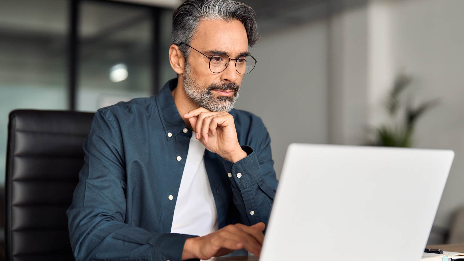 uncompetitive intelligent man working on his laptop