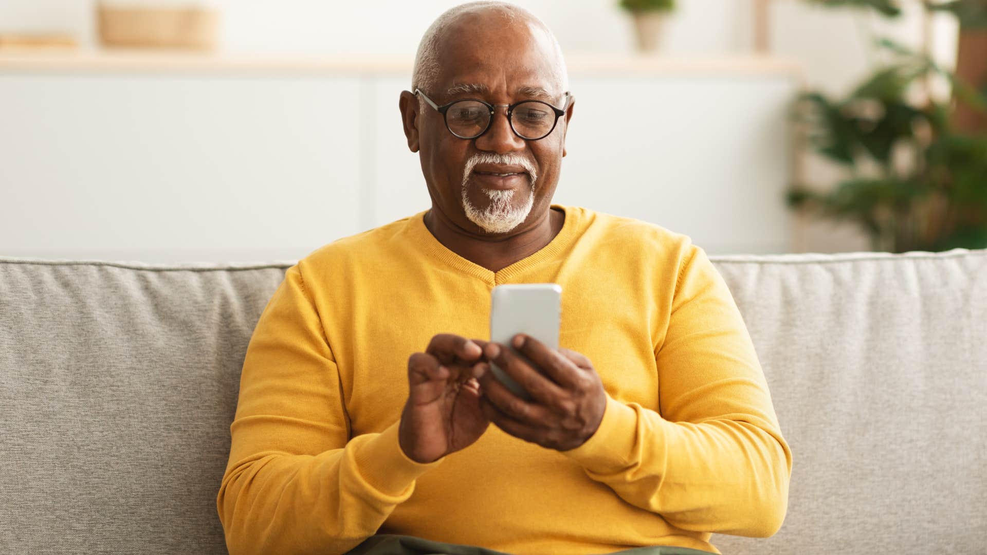 older man distracting himself on his phone