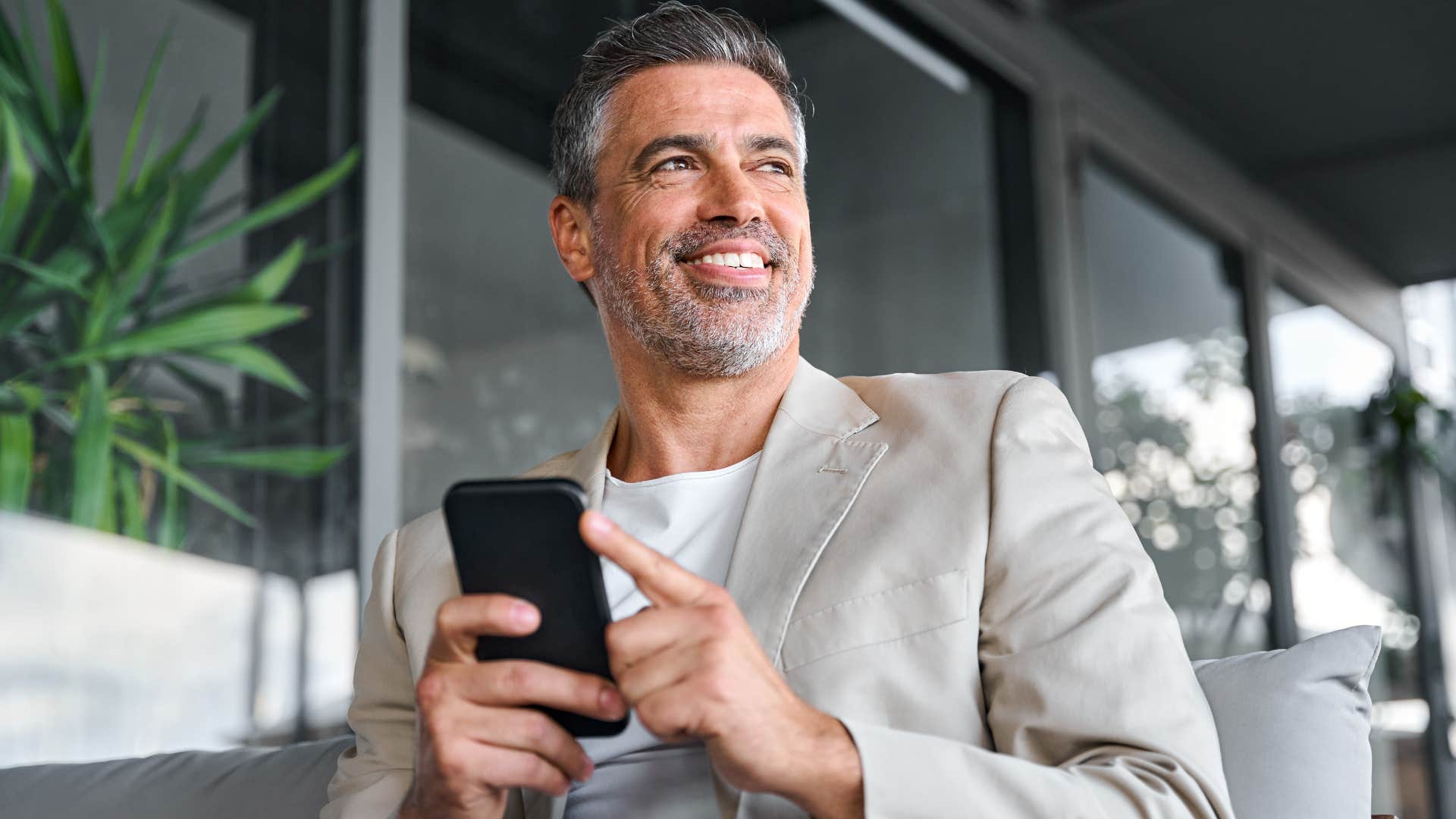 man overspending using his phone while at work