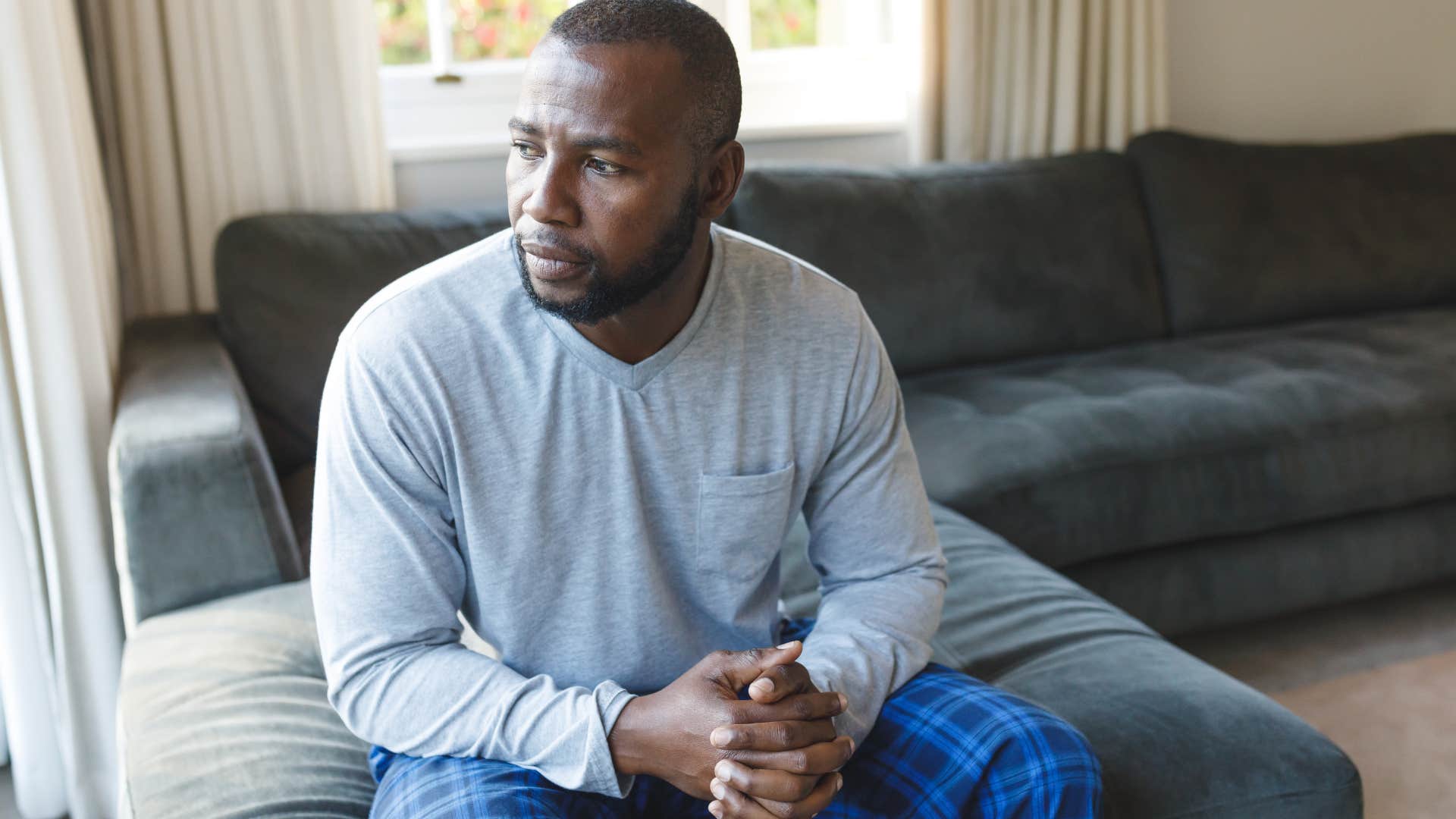 Man leaning into solitude at home