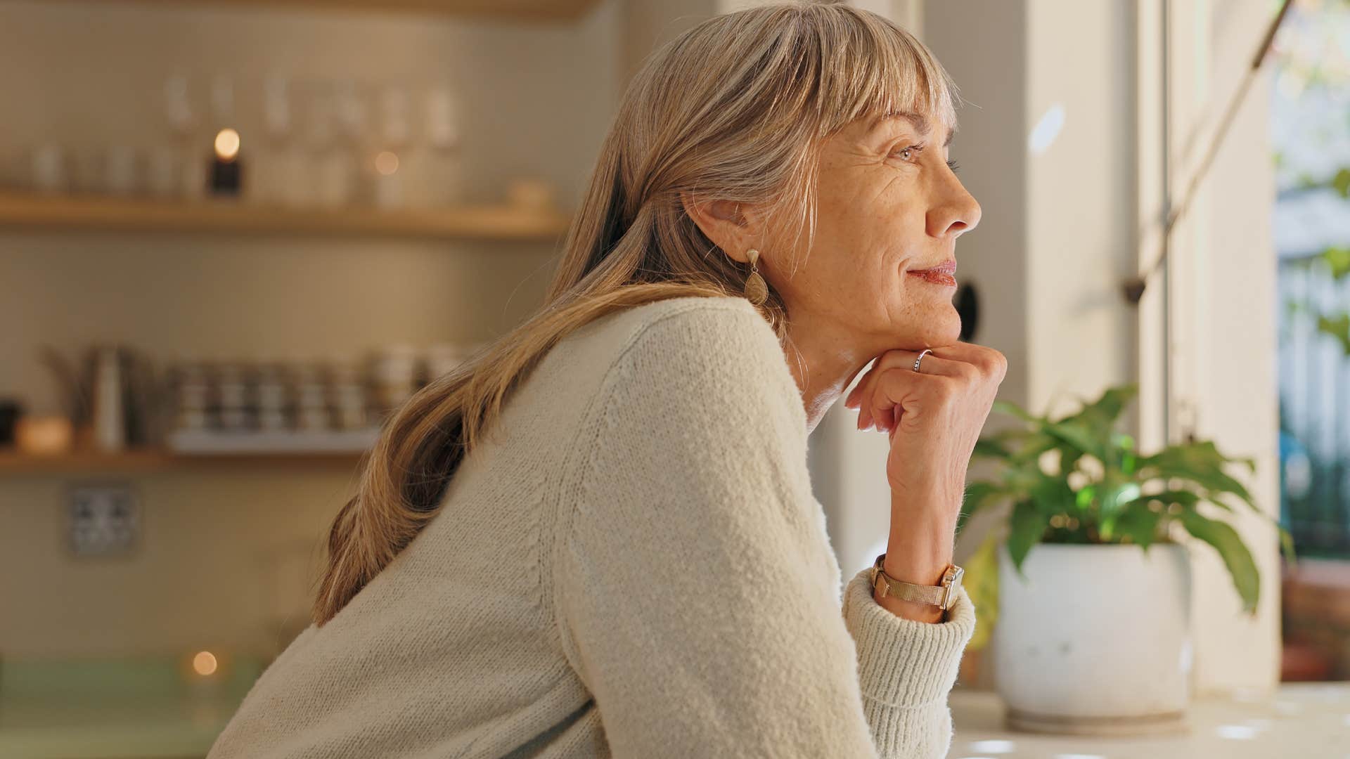 Woman feeling deeply present in her life looking out a window