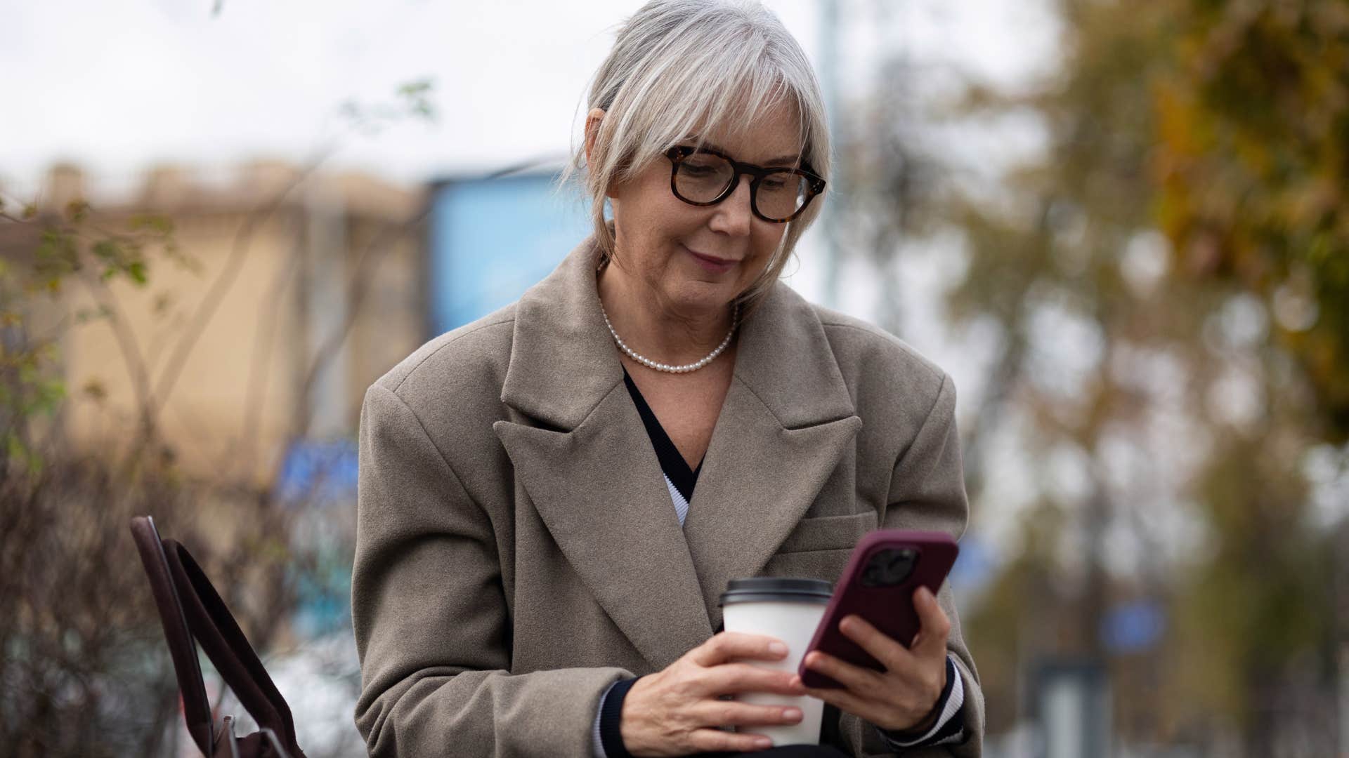 boomer woman reading clickbait headlines on her phone