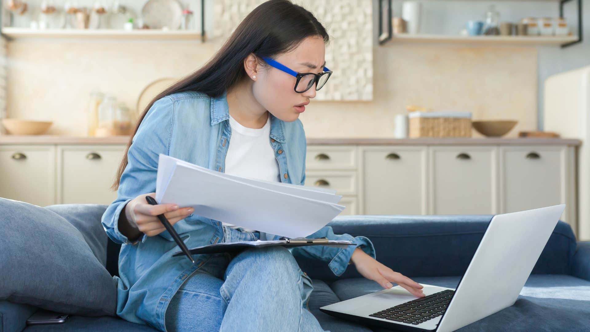 woman looking at hidden fees while doing bills