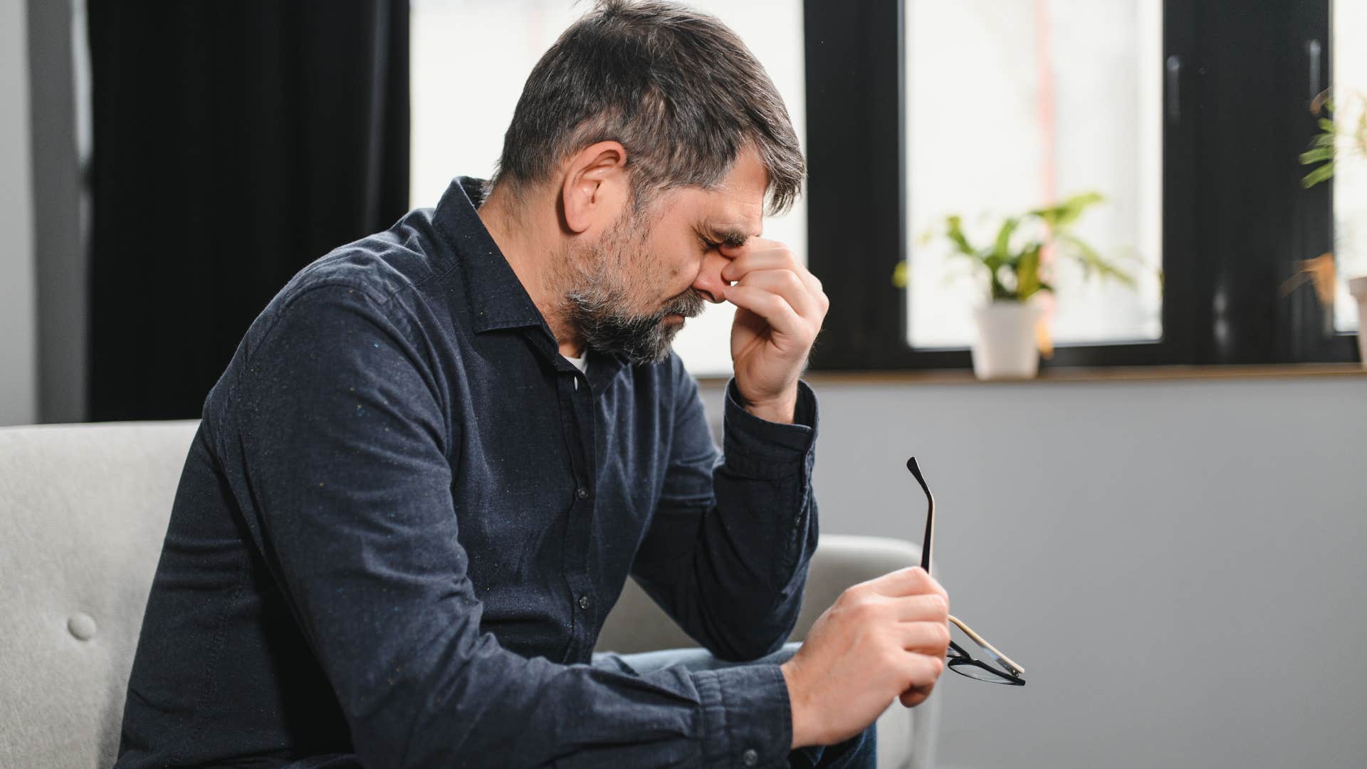 man feeling shame about changing careers holding his head