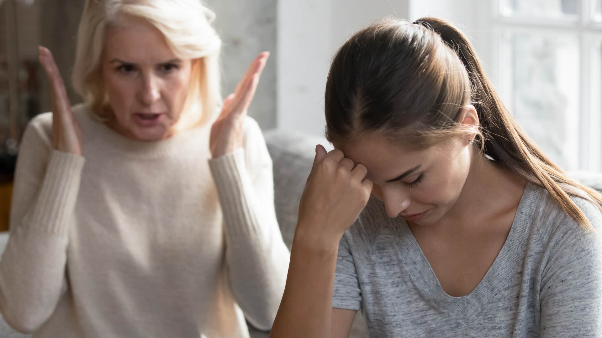 Woman upset in front of her mom who's always comparing them to others.