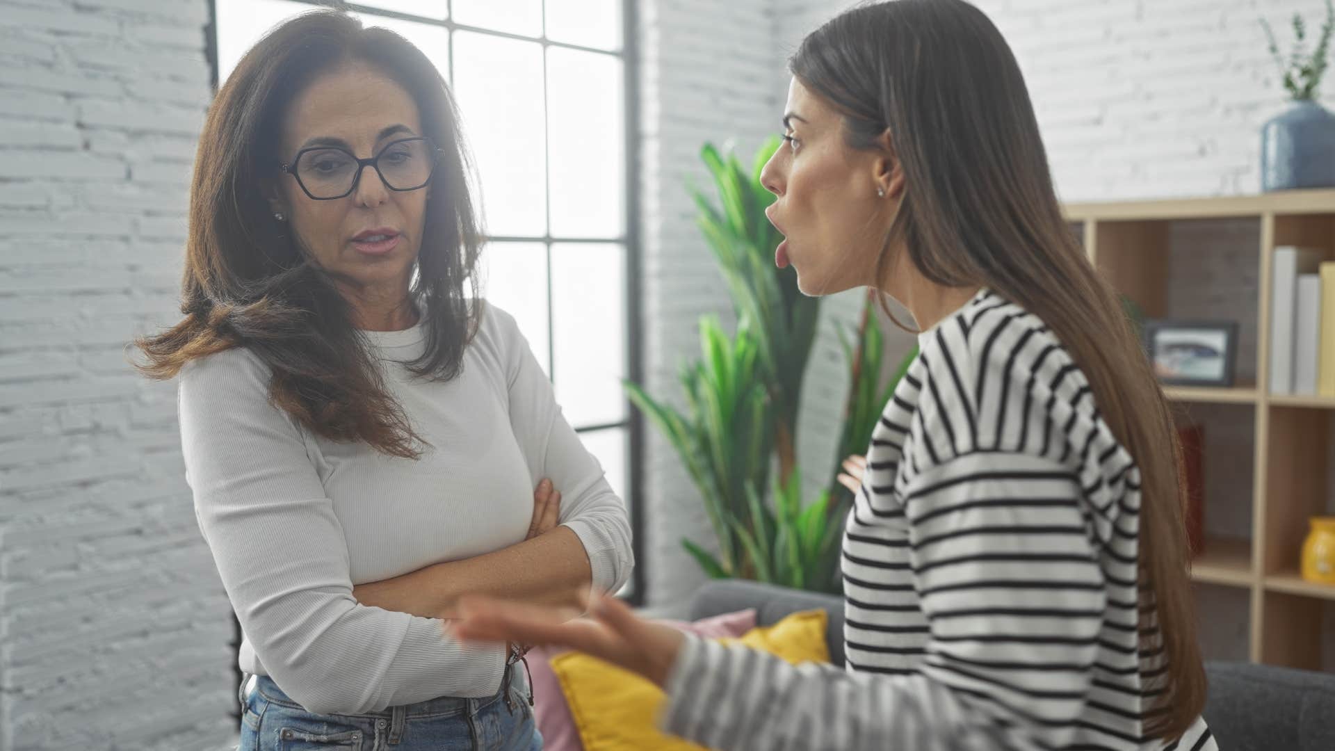 Woman playing the victim while talking to her angry daughter.