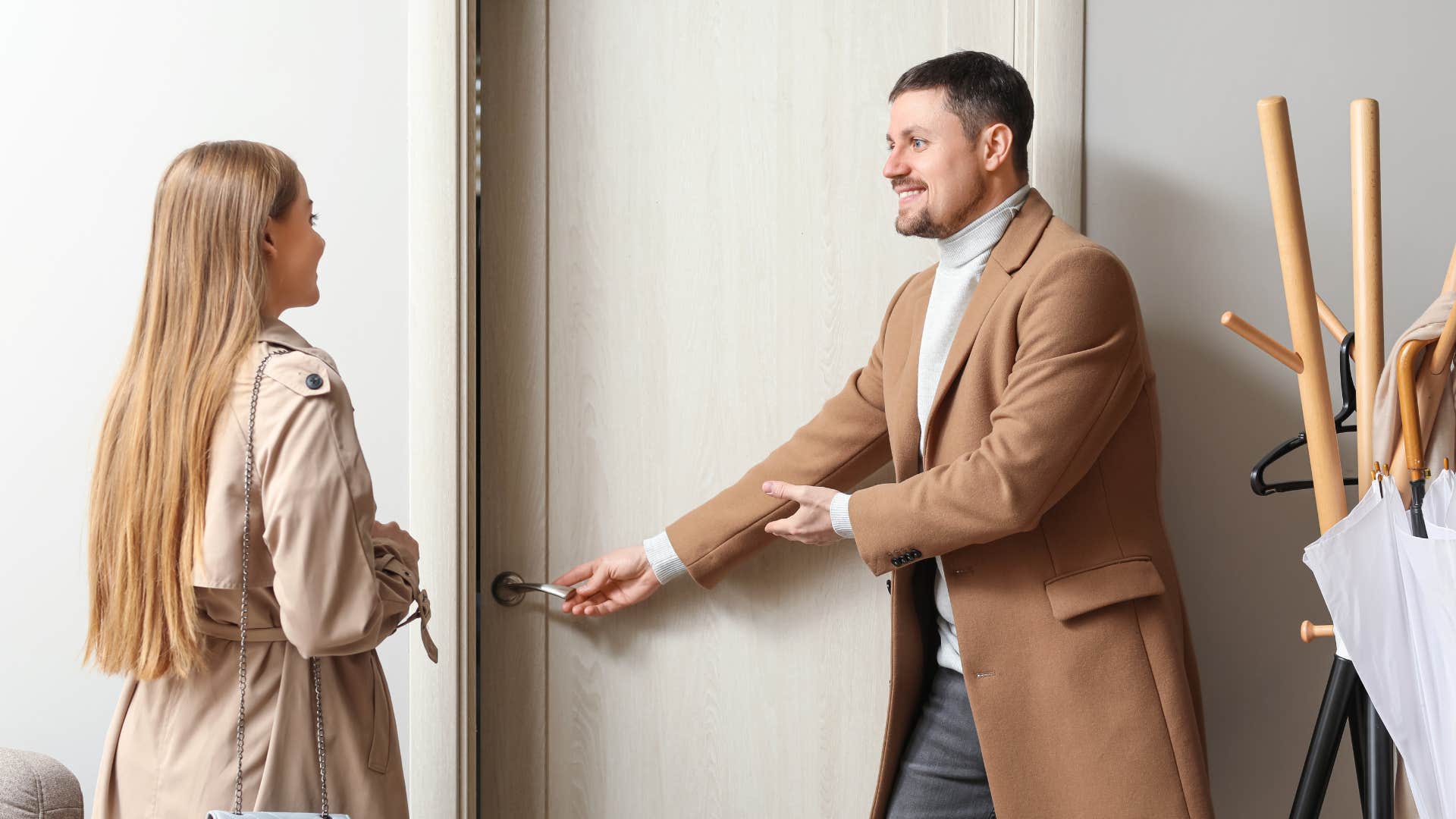 woman waiting for man to open the door politely