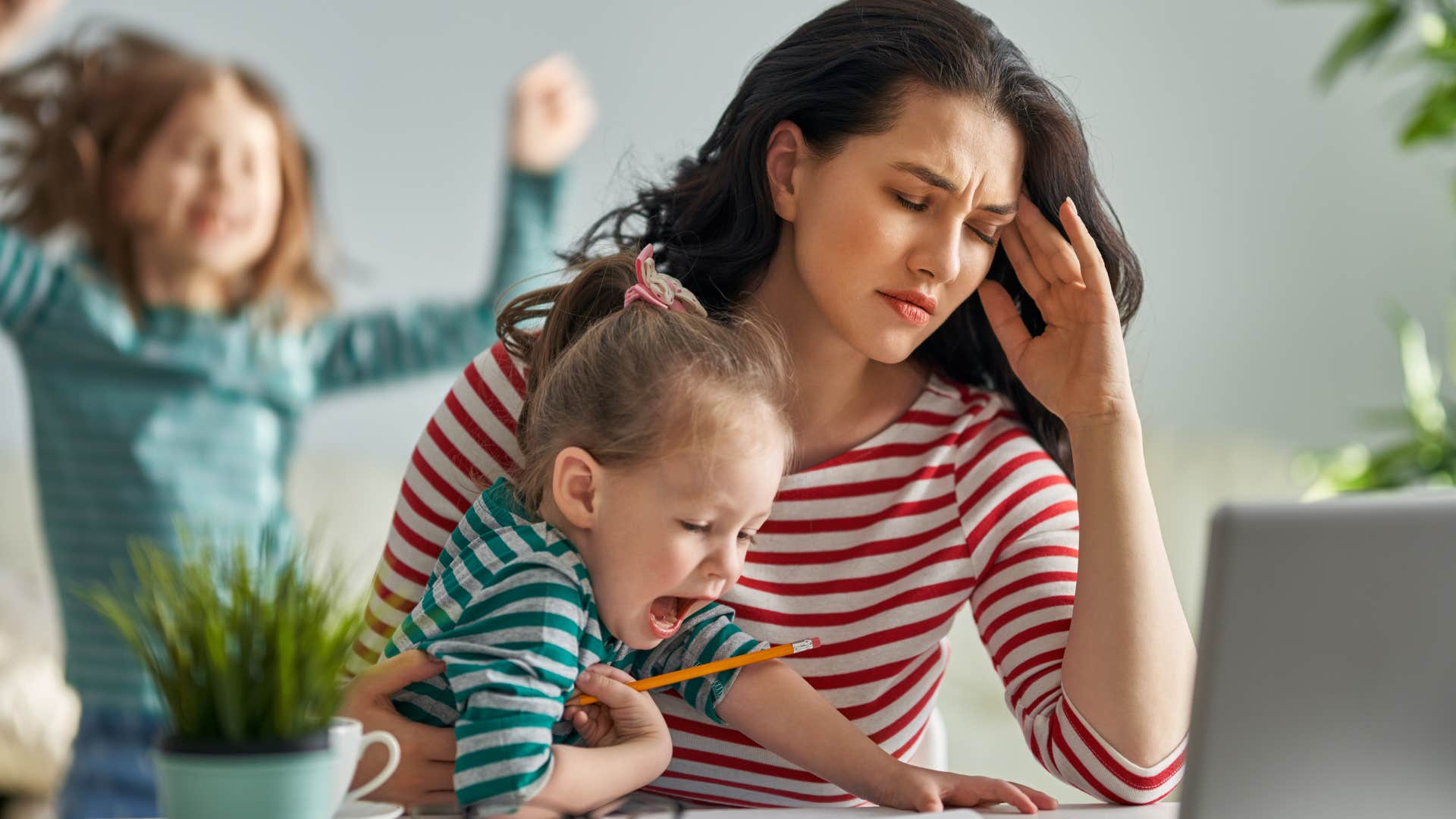 woman with no free time watching her kids