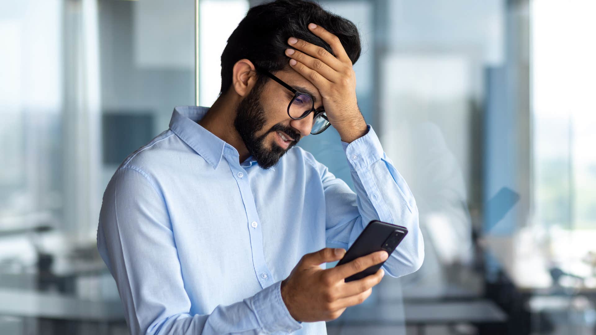 stressed man googling his sickness symptoms on his phone