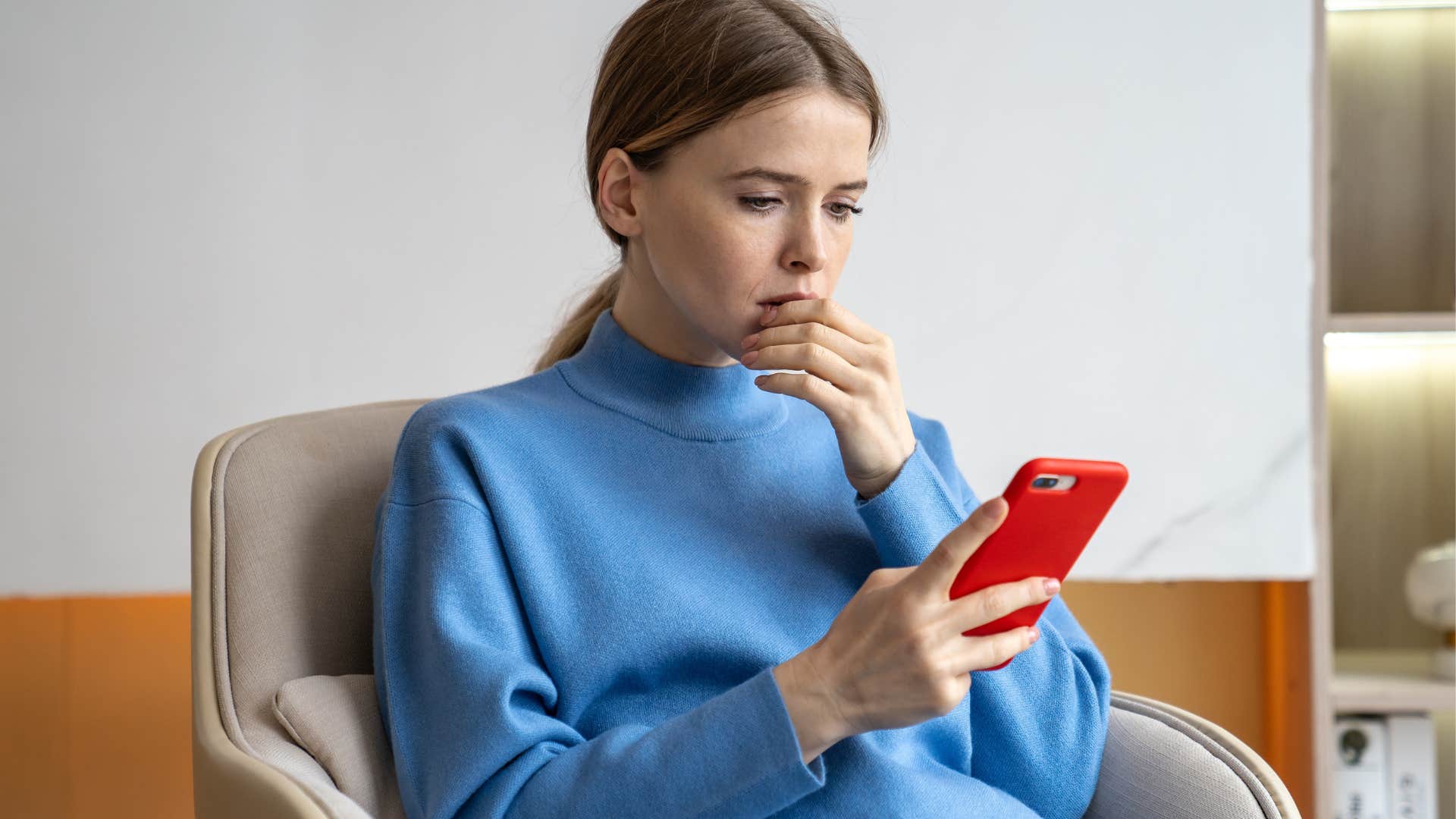 stressed woman constantly watching the news on her phone