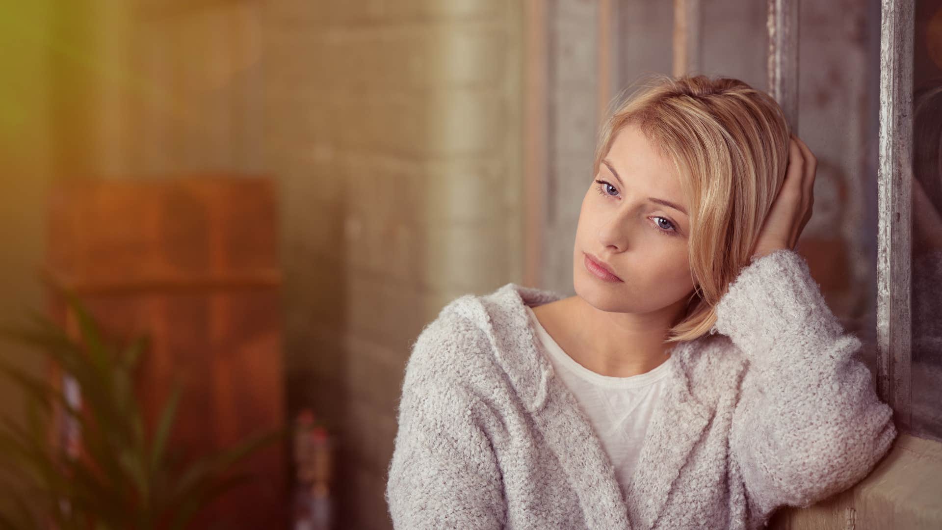 upset woman thinking while sitting at home