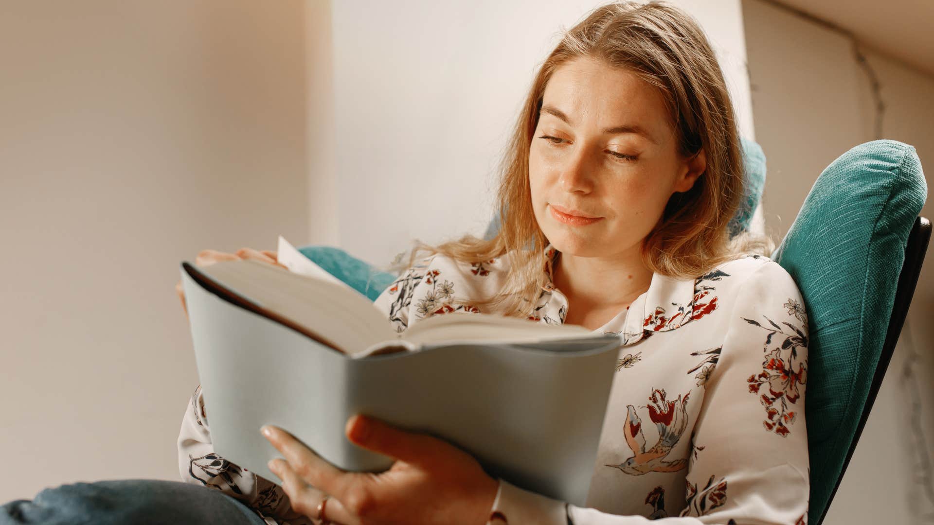 woman overcoming boredom by reading at home