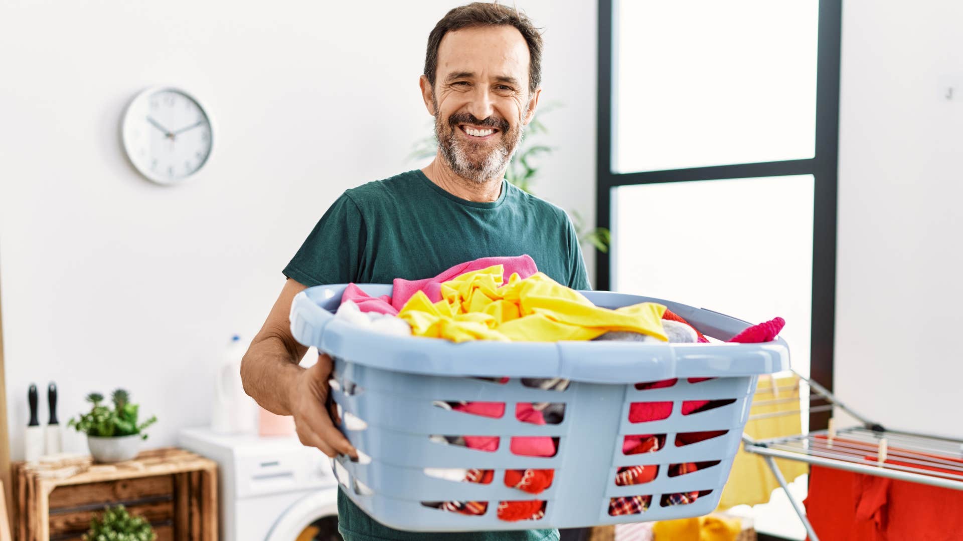 man practicing self-discipline by doing the laundry at home