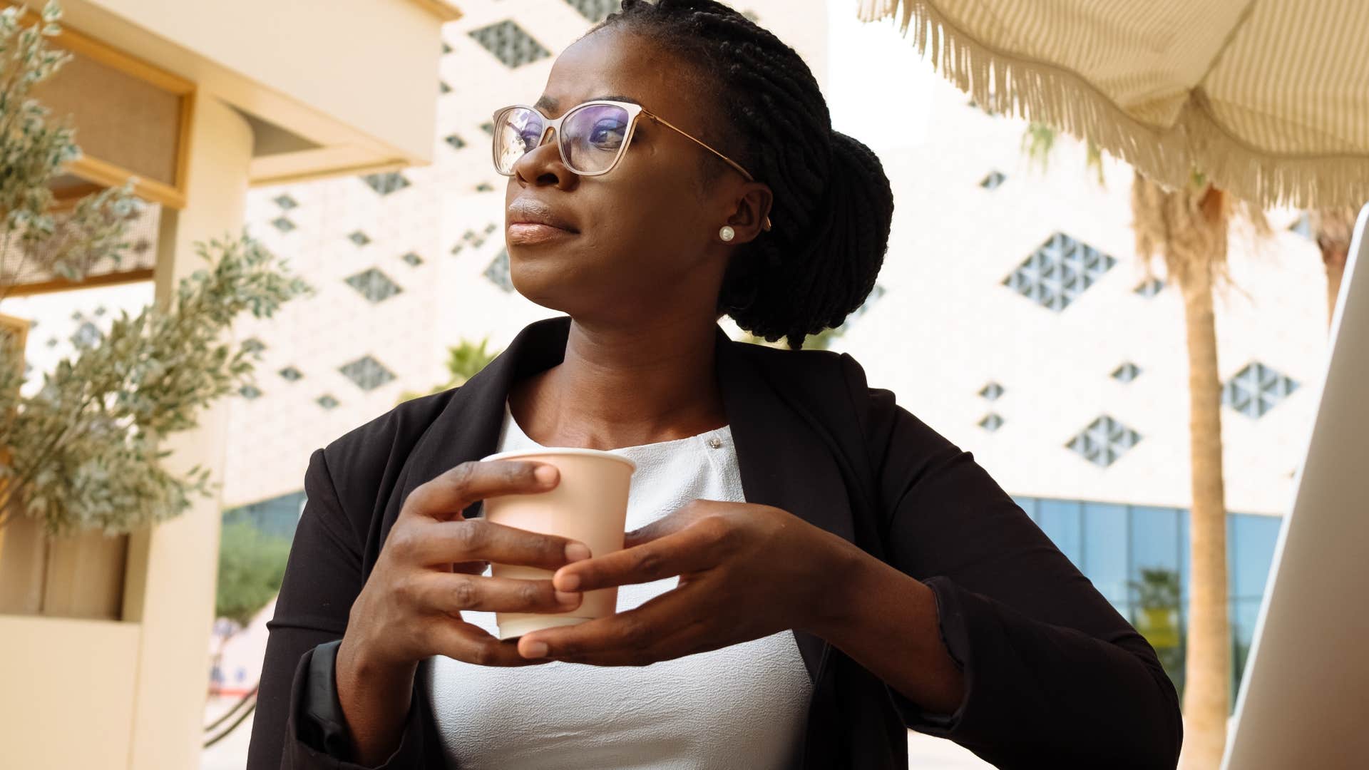 woman solving problems while drinking coffee thinking