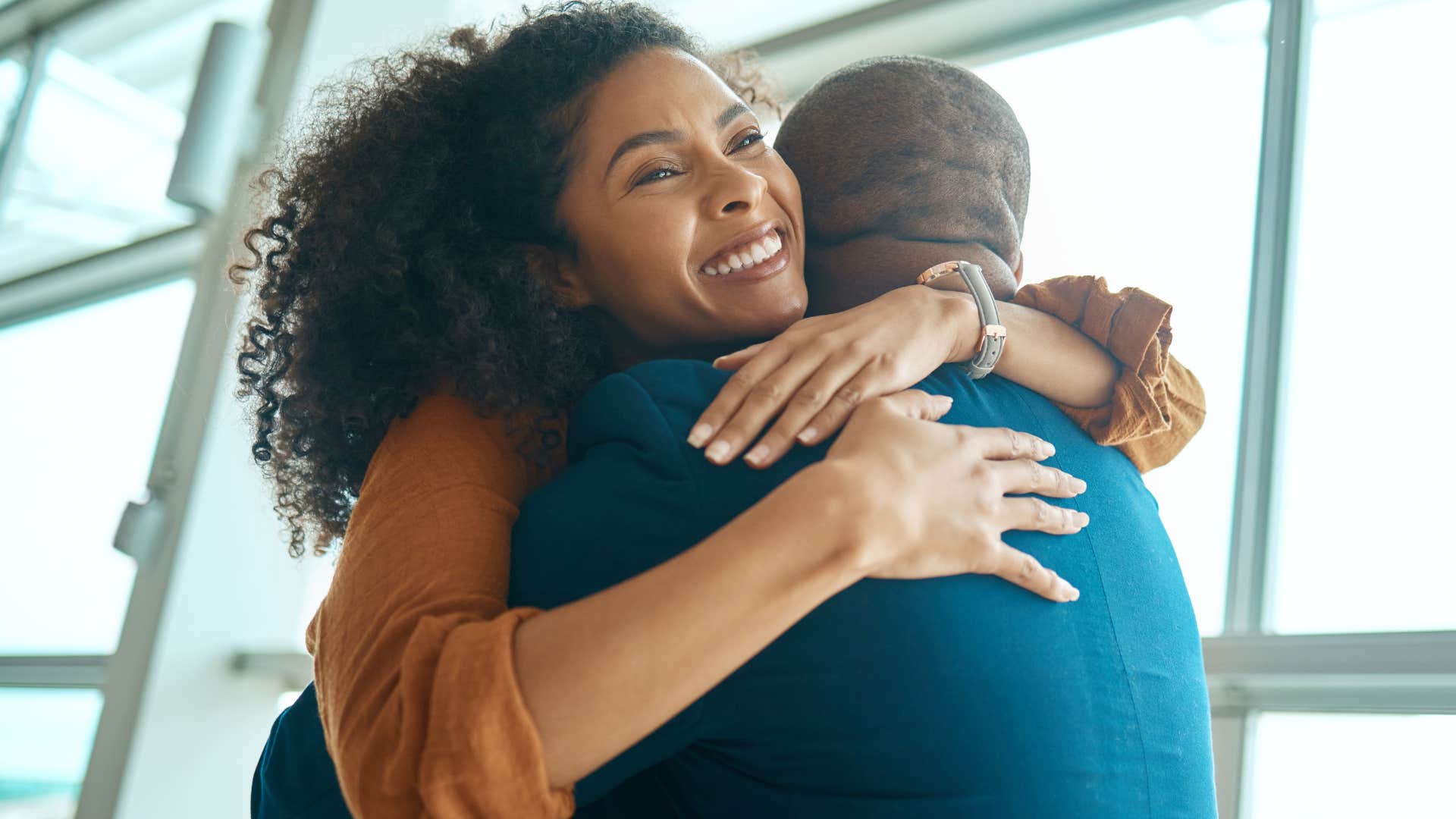 woman showing gratitude for her partner hugging him