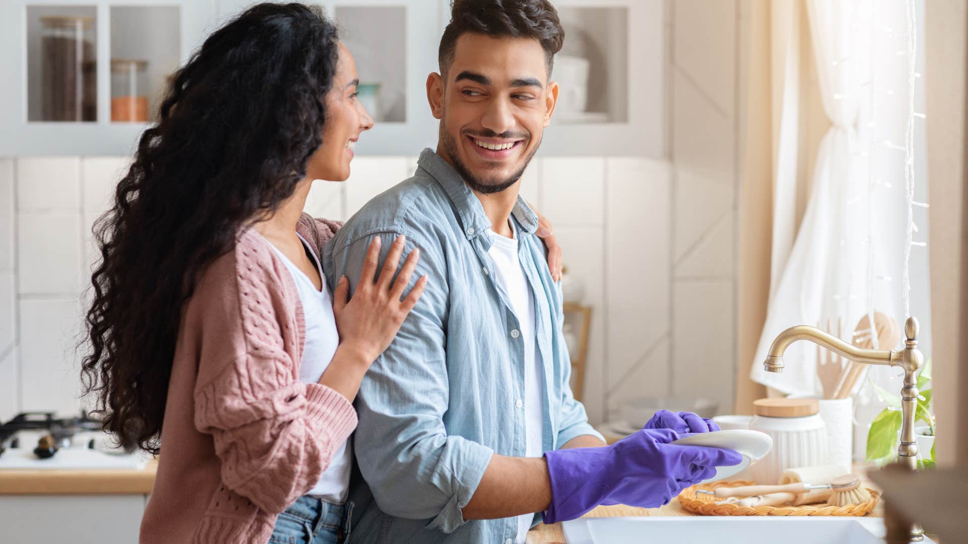 man helping his partner do dishes