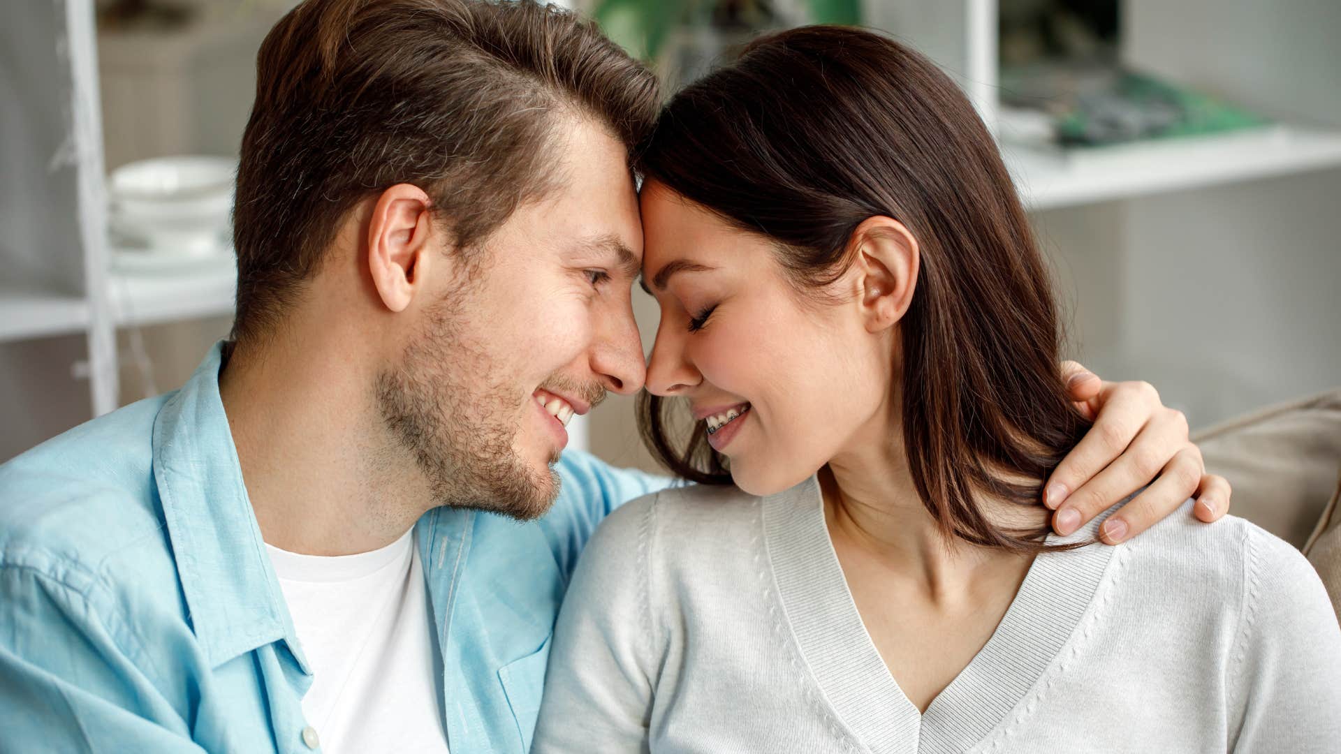 couple putting their heads together smiling