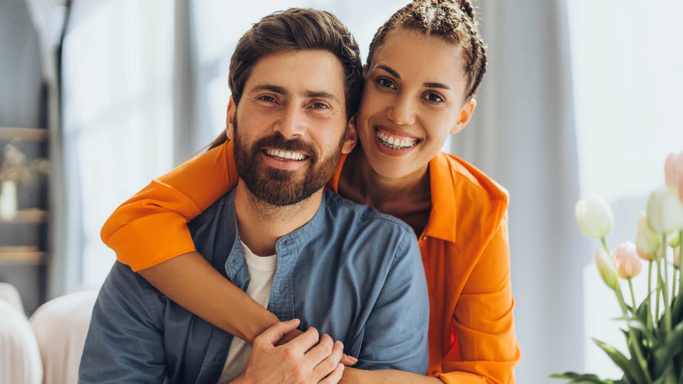 Tiny Things That Reveal Deep Love Before Words Ever Do, According To Psychology happy loving couple embracing hugging