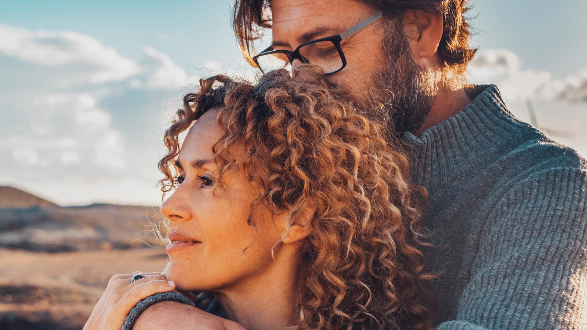 patient man hugging and kissing his partner from behind