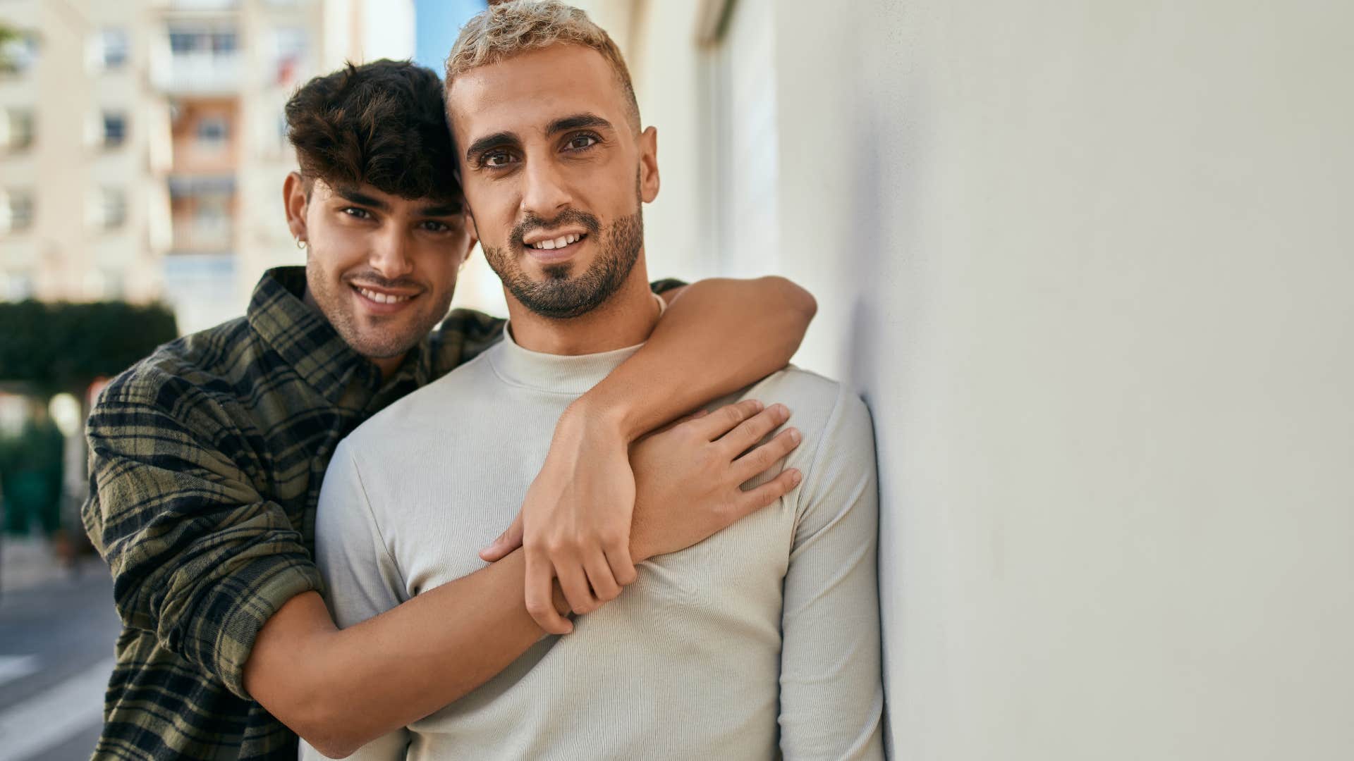 man feeling protective of his partner hugging him from behind