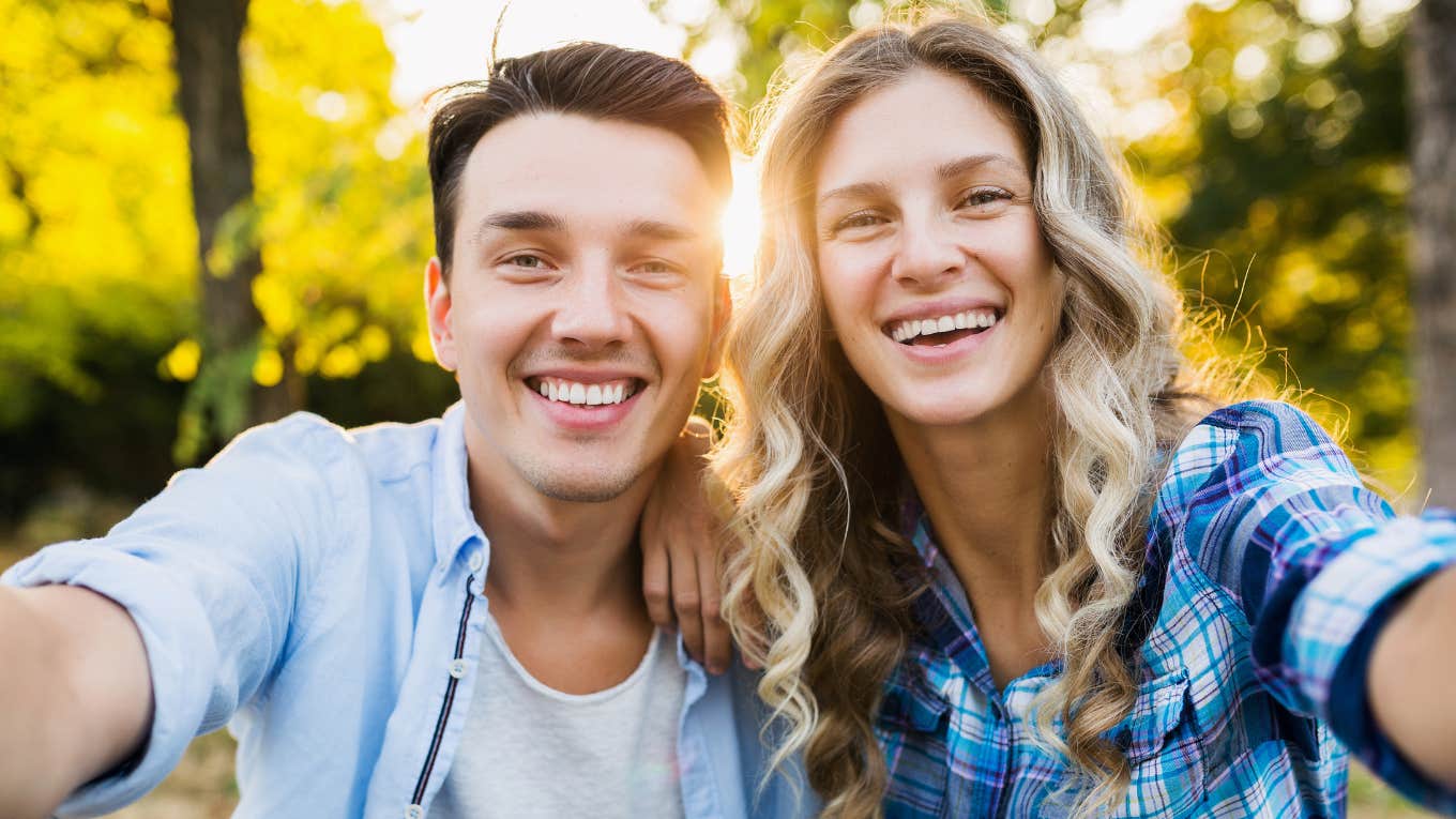 Tiny Ways A Man's Energy Changes Around The Person He Loves Most, According To Psychology happy man taking selfie with the woman he loves