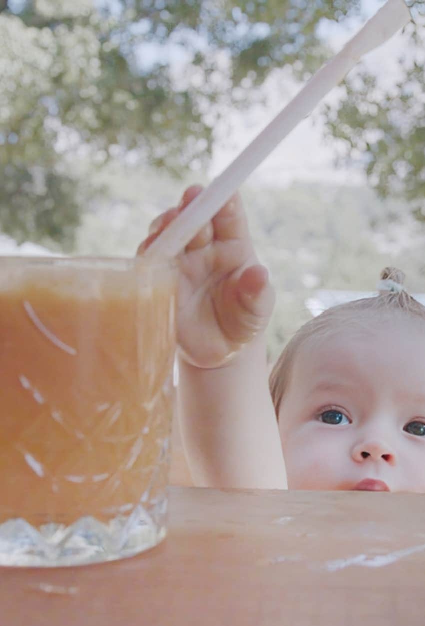 toddler reaching for alcohol cup
