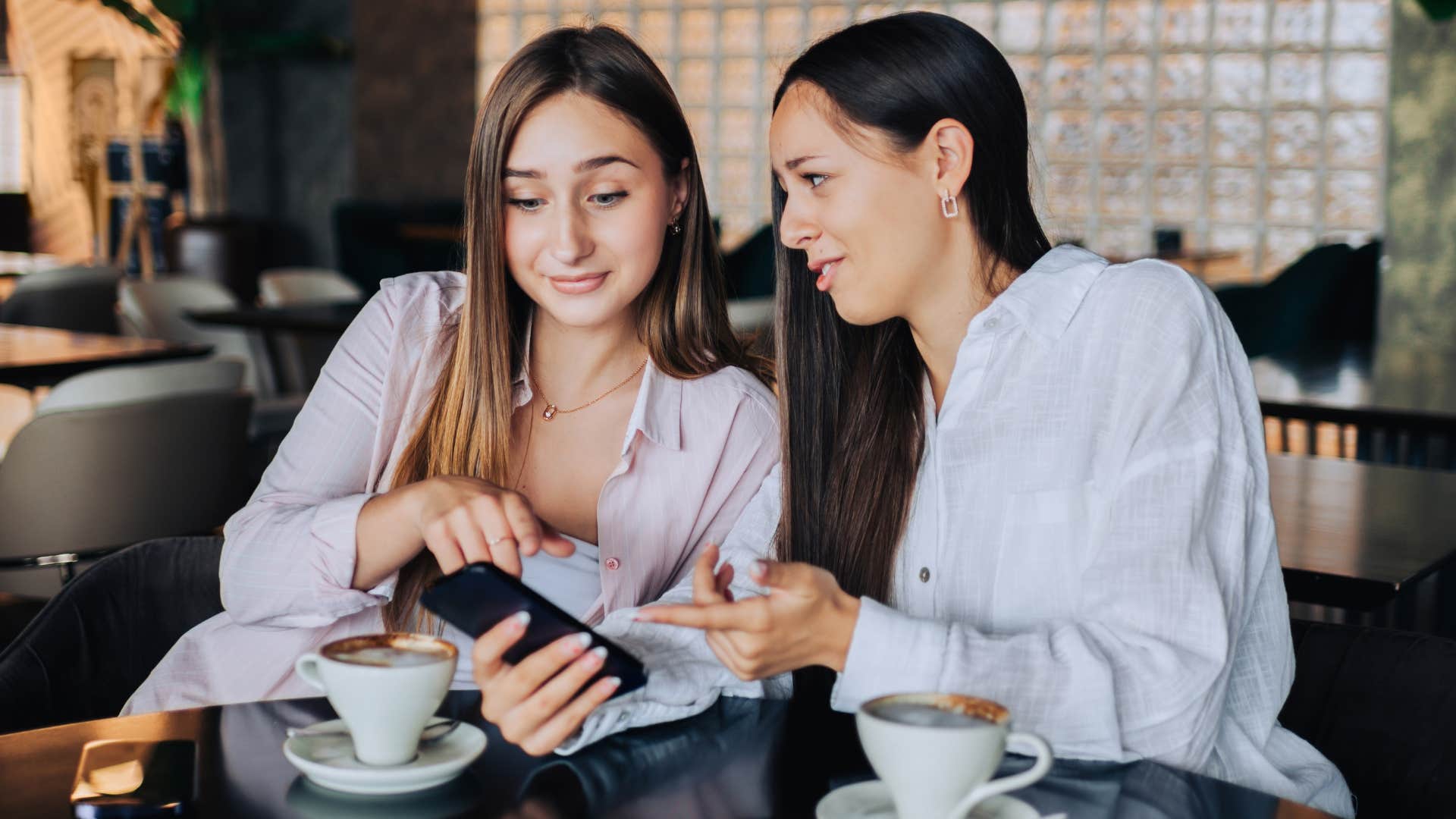 two friends with low integrity gossiping over coffee
