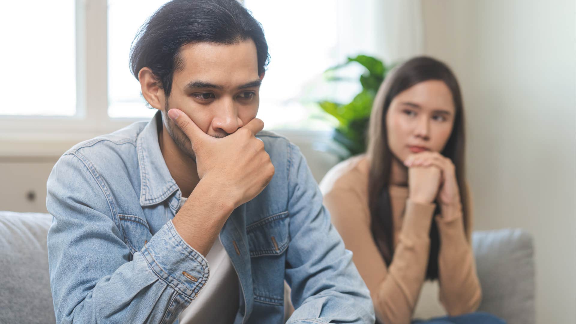 man withholding affection turned away from his partner