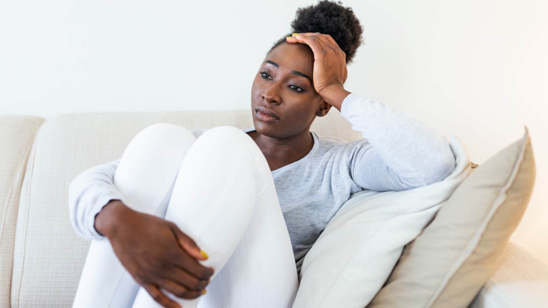 woman sitting on couch upset she isnt getting what she wants