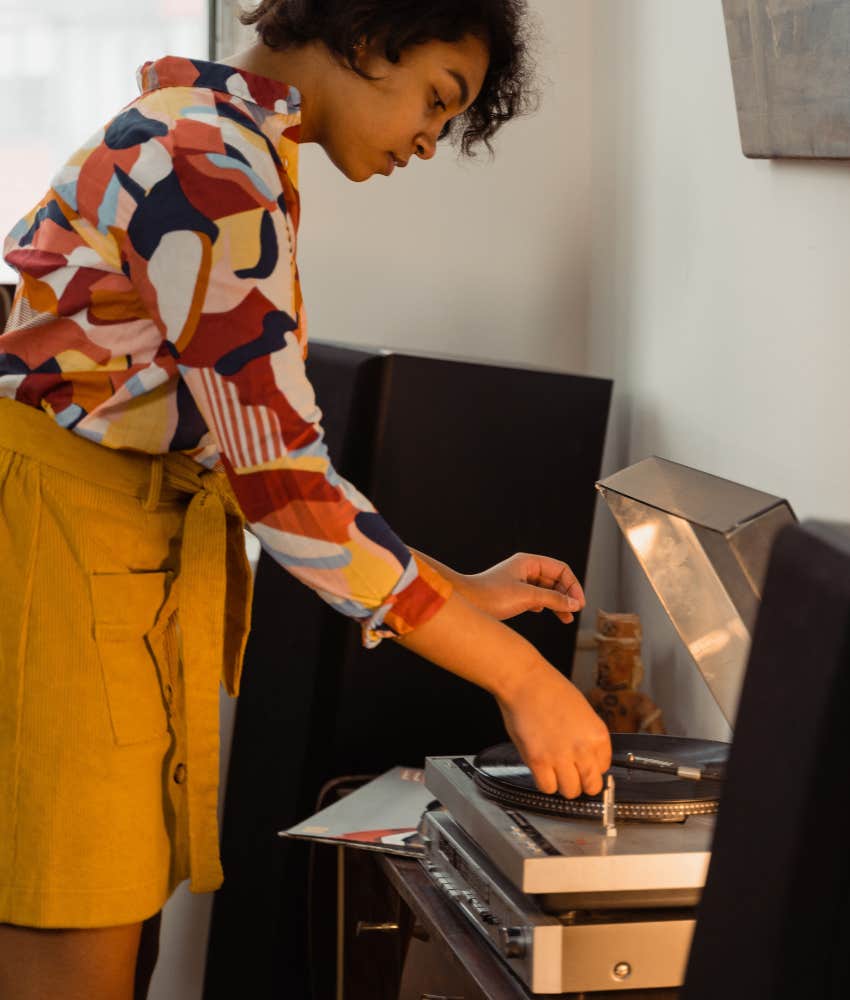 Zillennial woman nostalgically listening to records makes her different from other generations
