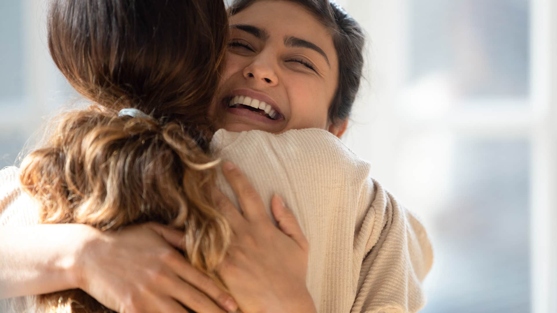 woman hugging friend and forgiving