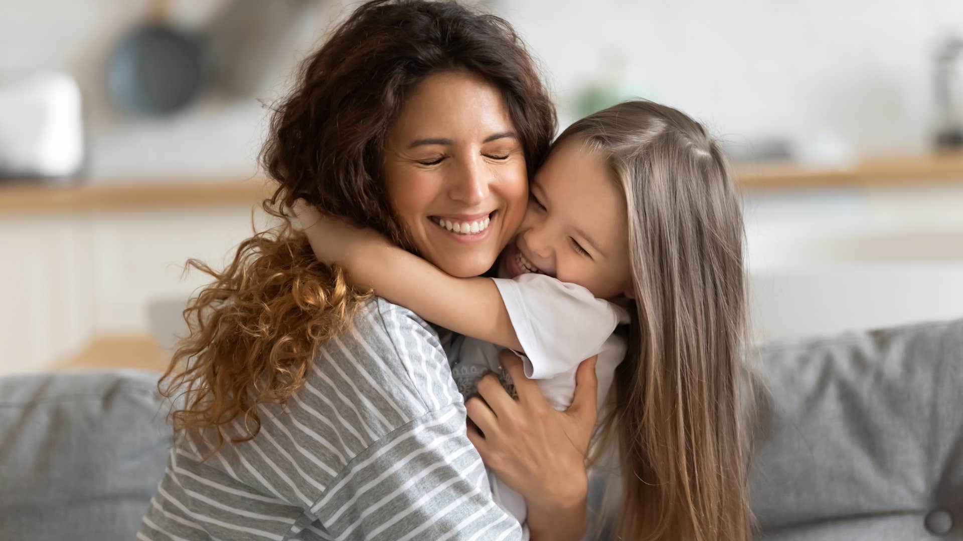 resilient mom hugging daughter happily