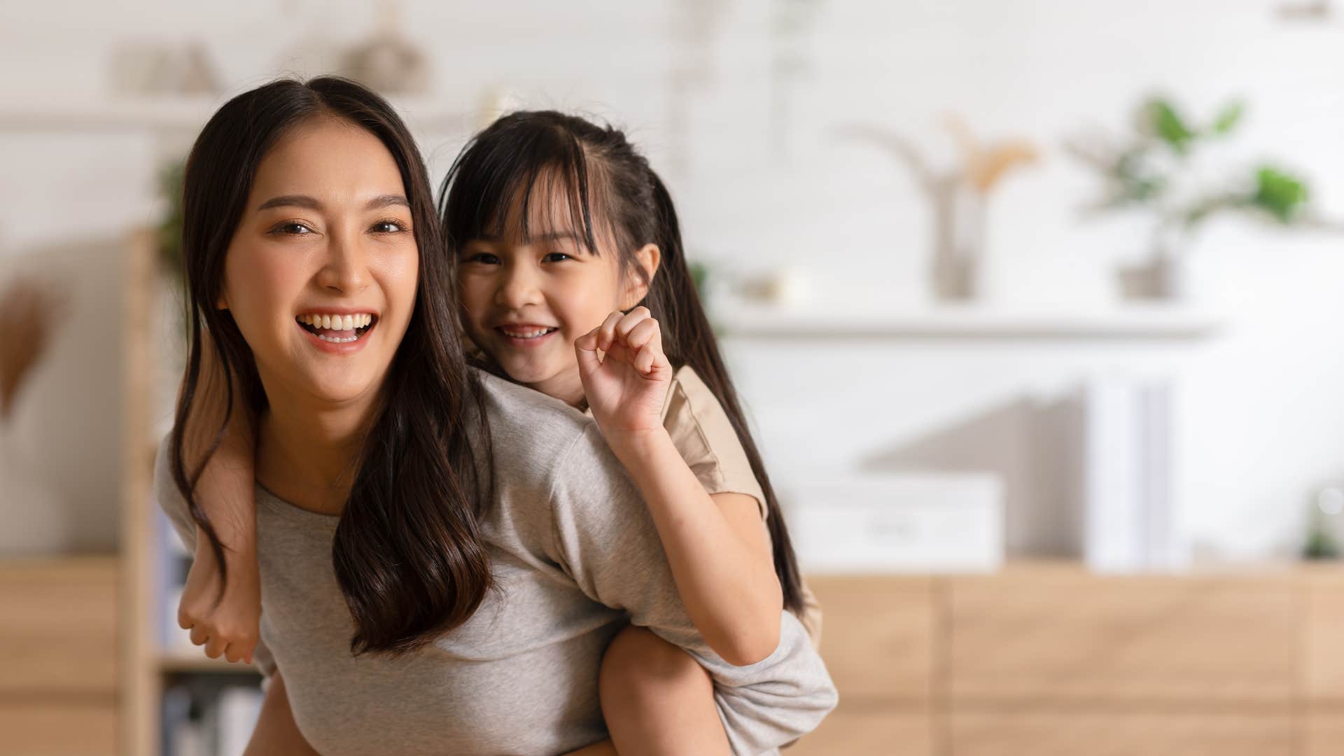 mom cuddling with her daughter rich in parenthood