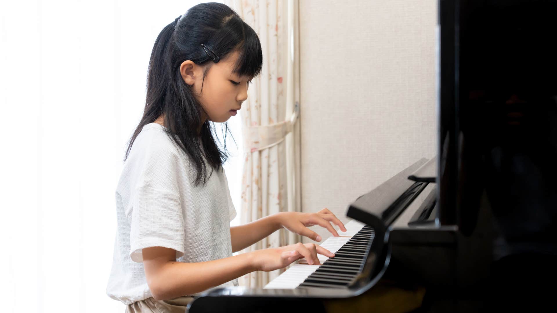 young girl plays the piano because her parents overscheduled her life