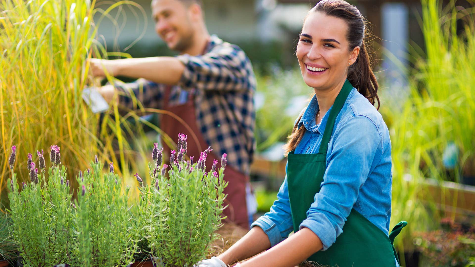 smiling woman working on messy landscaping outside