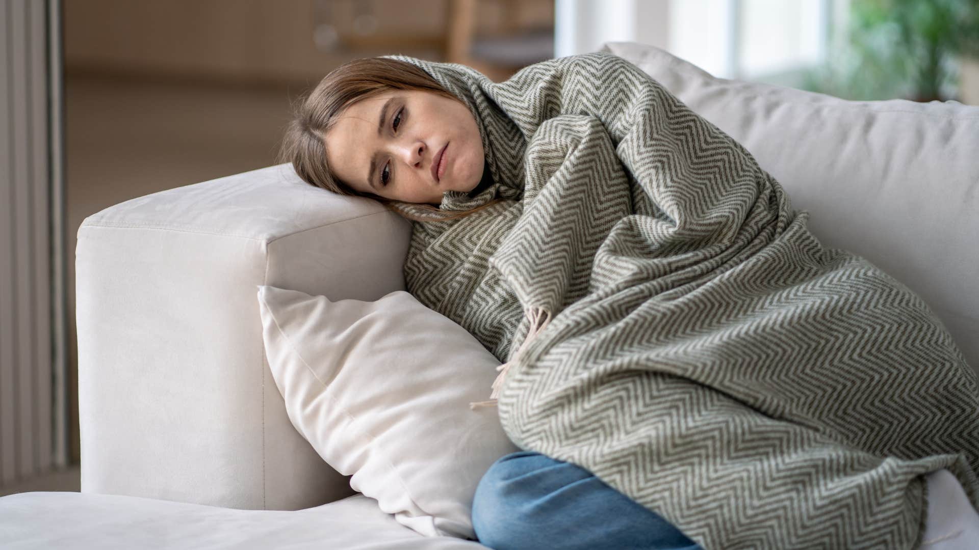 burned out woman resting on her couch