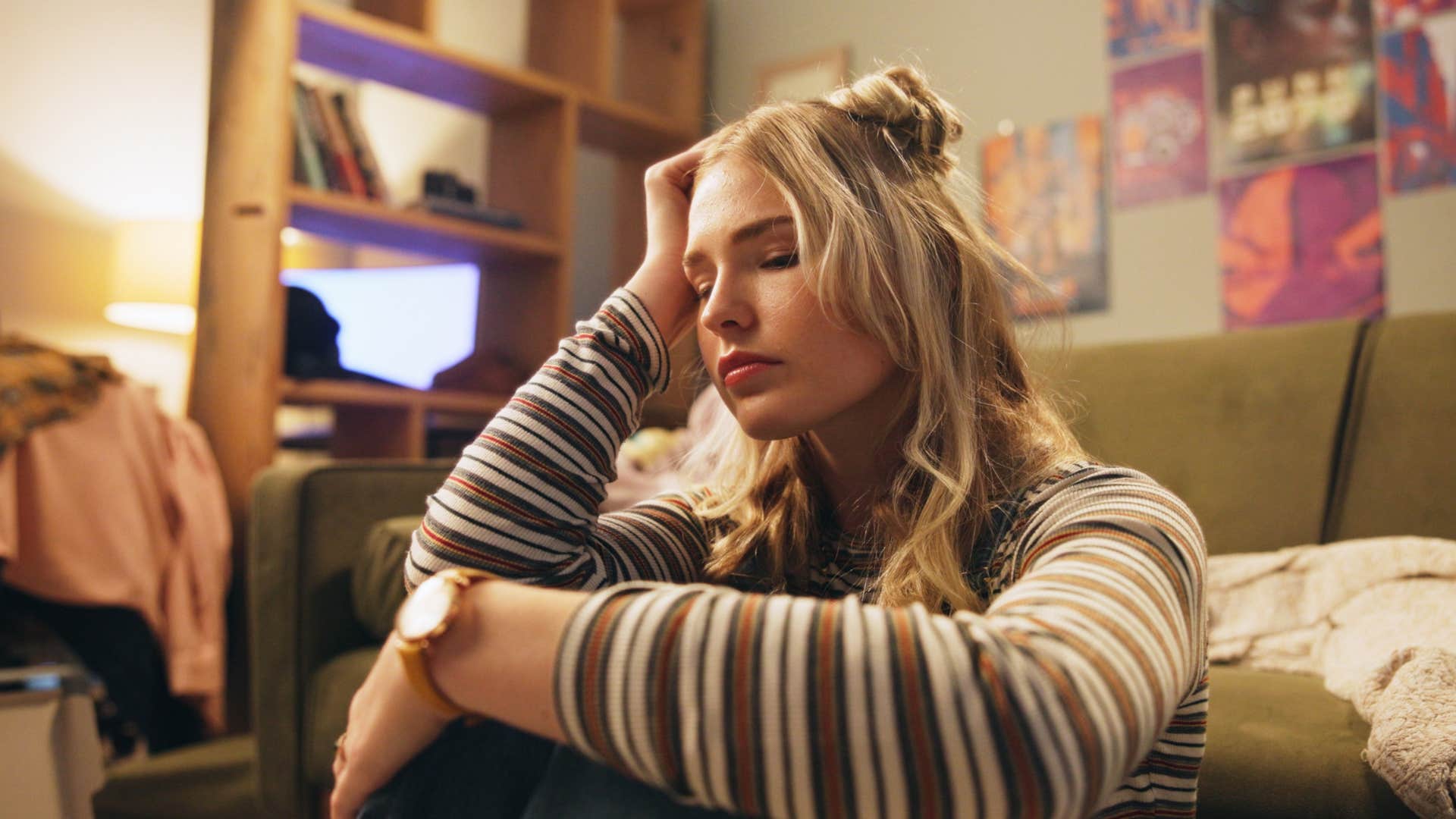 woman sitting on floor realizing she doesnt look or feel like herself anymore