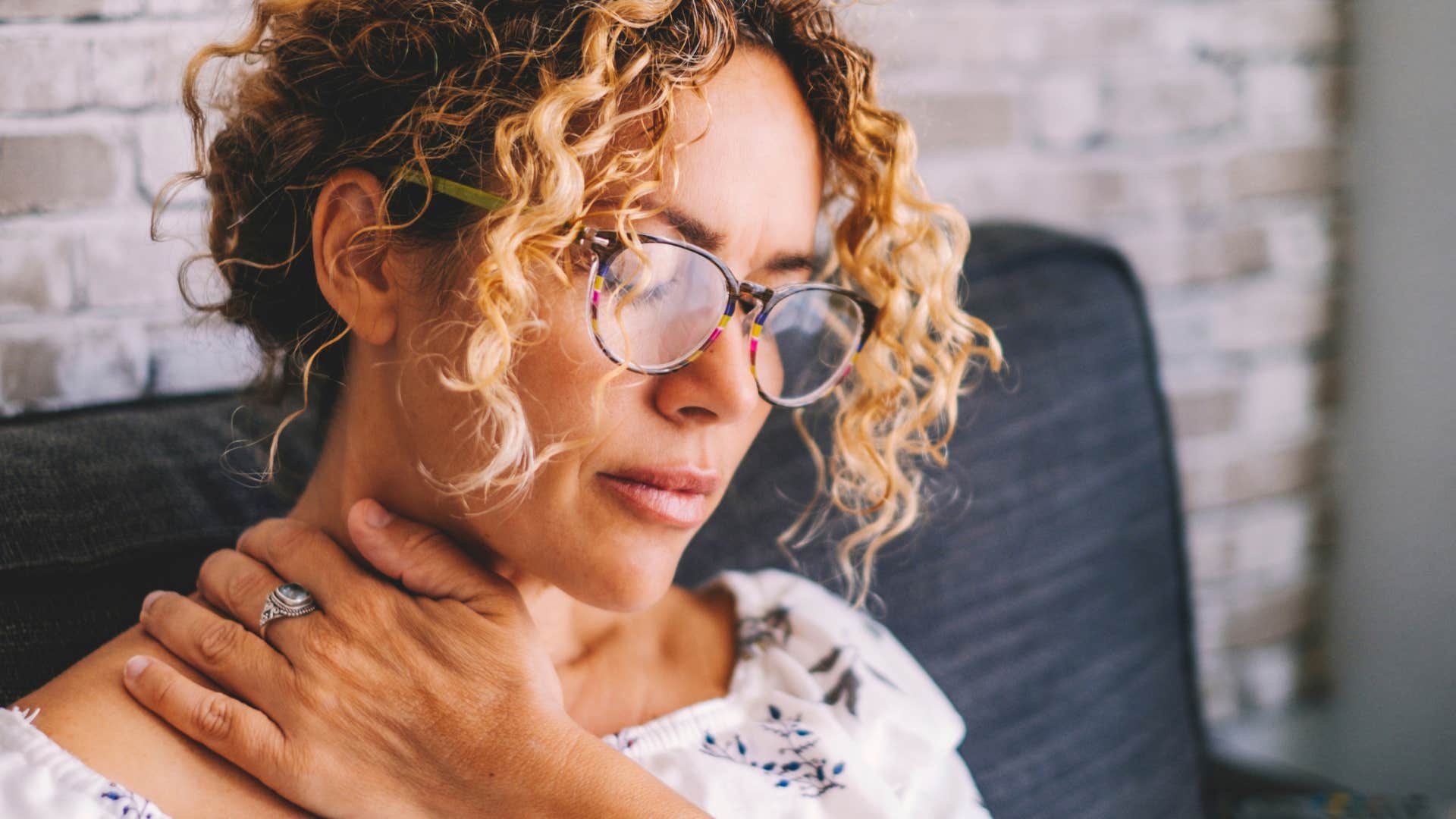 woman touching wound on neck thats taking long to heal