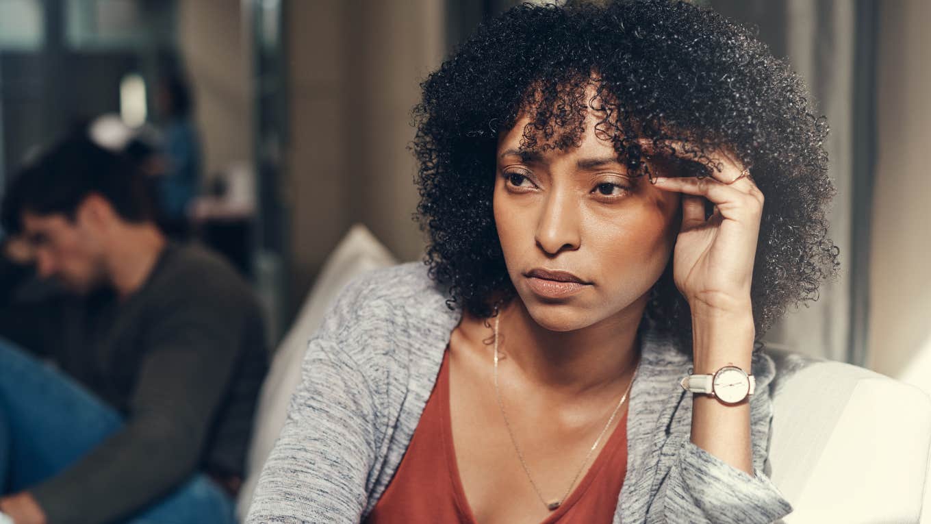 Ways A Woman's Body Reveals She's With The Wrong Man, According To An Expert woman holding head in pain from toxic relationship