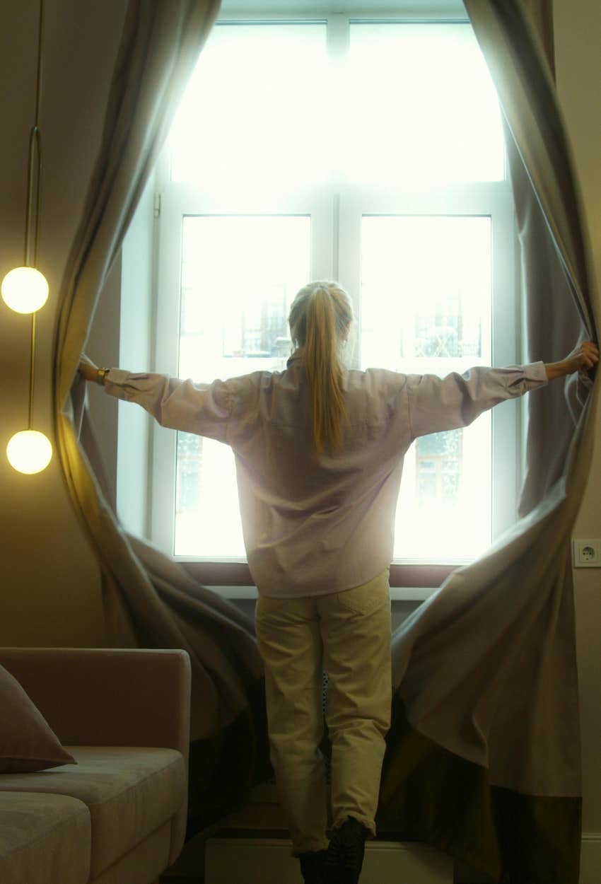 woman looking for her neighbor out the window