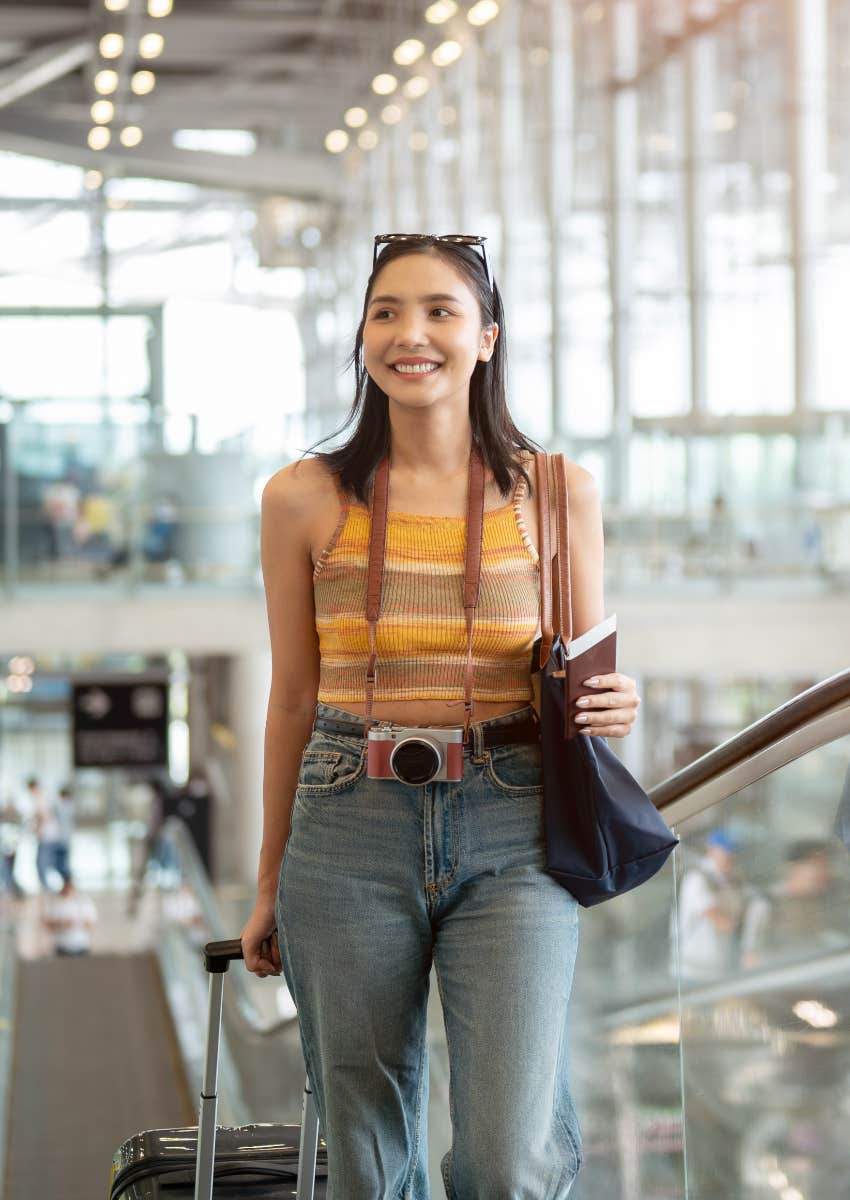 woman walking through airport going on vacation