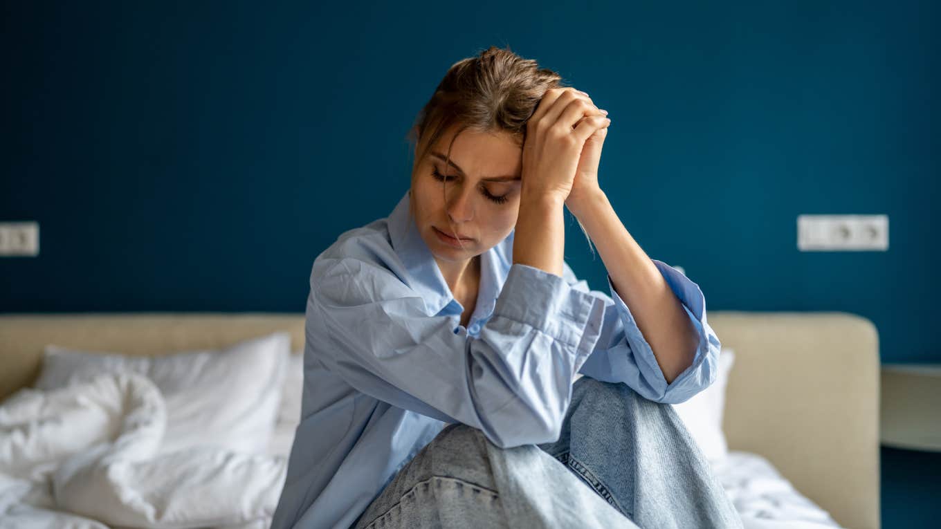 depressed woman sitting on bed
