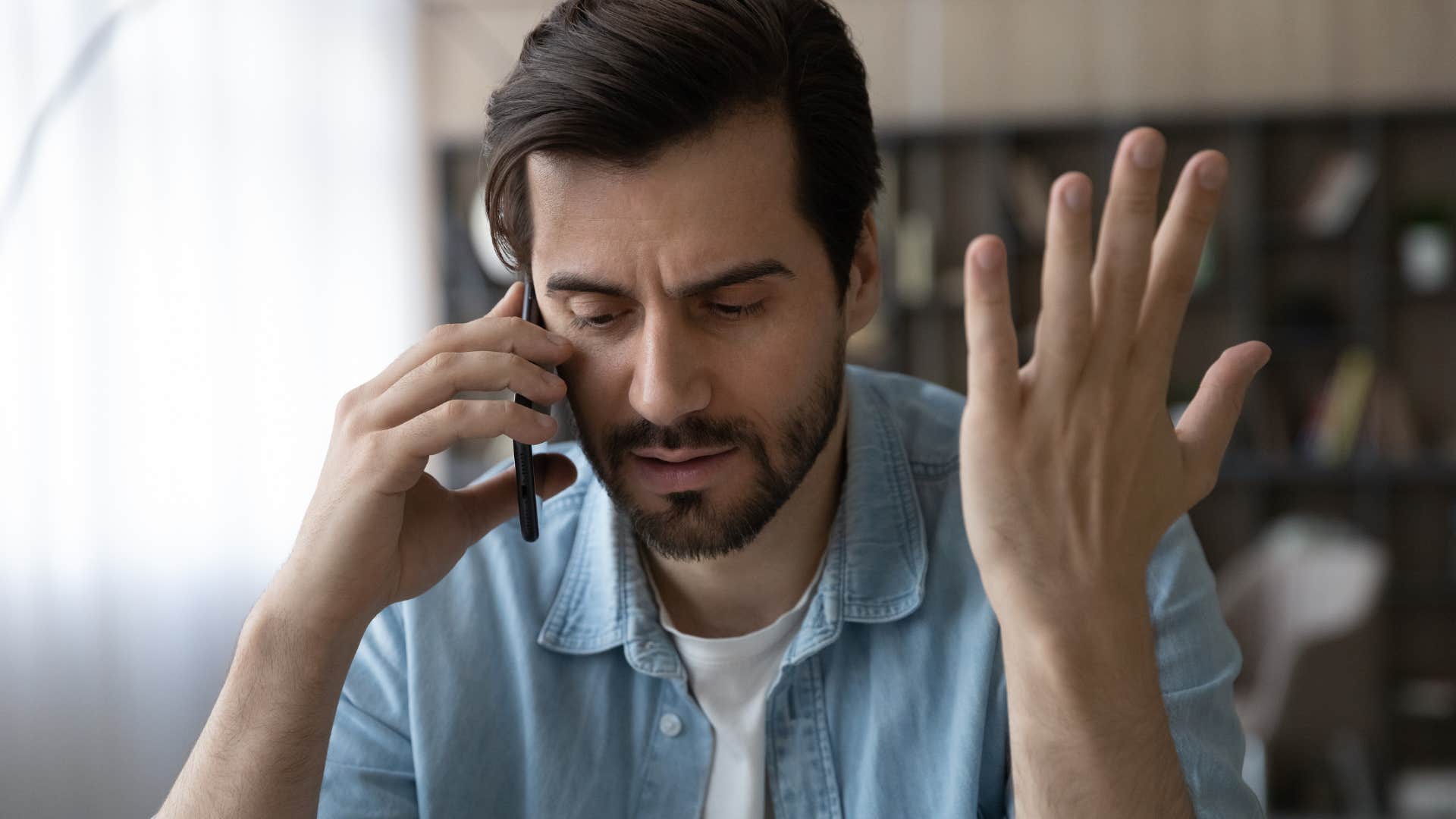 annoyed man on the phone canceling his plans last-minute