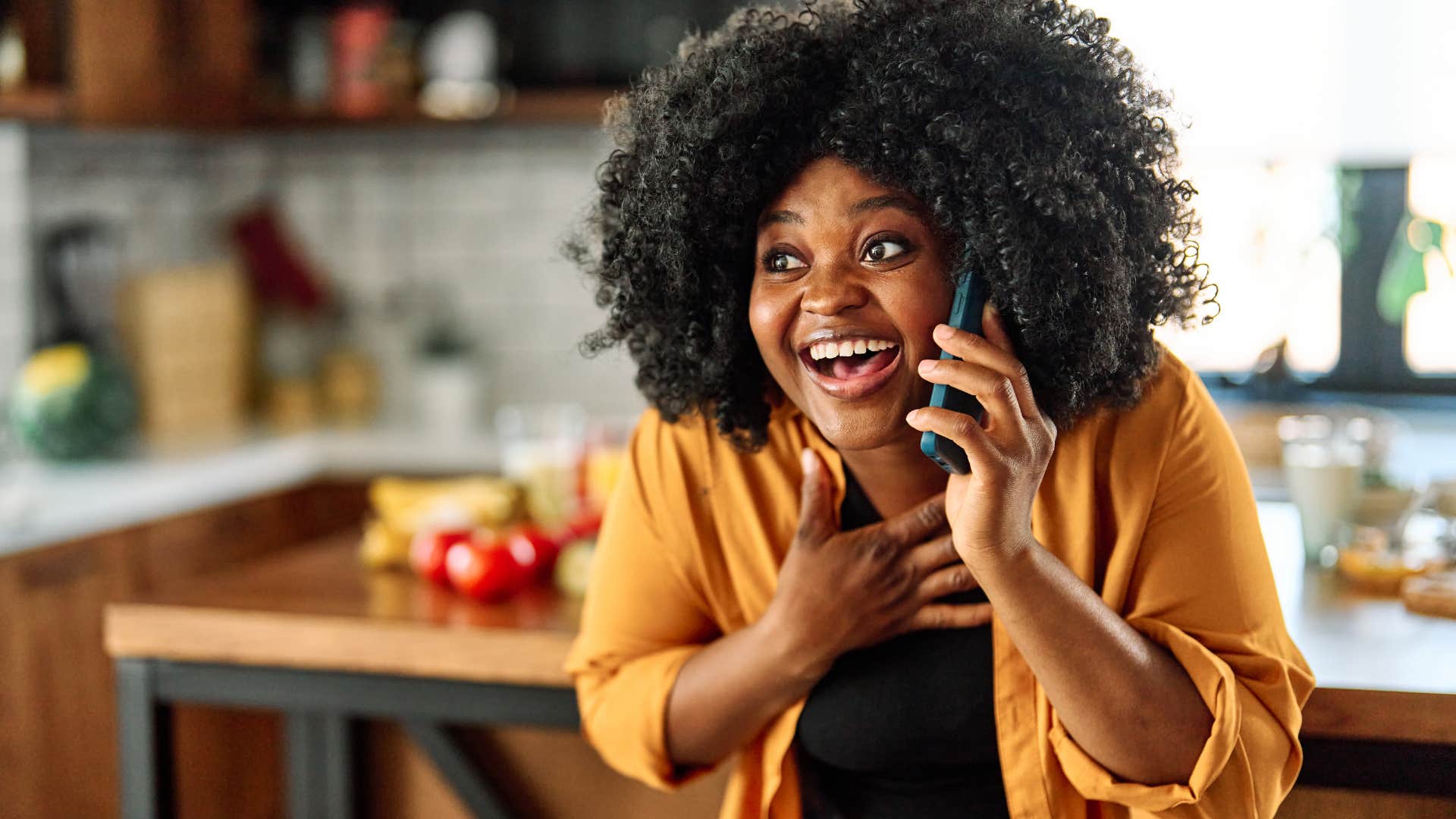 smiling woman on the phone wishing friend a happy birthday
