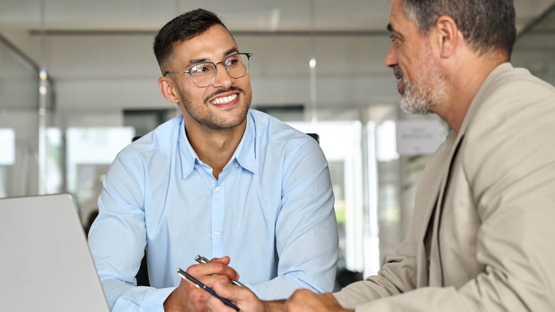 man smiling at his co-worker