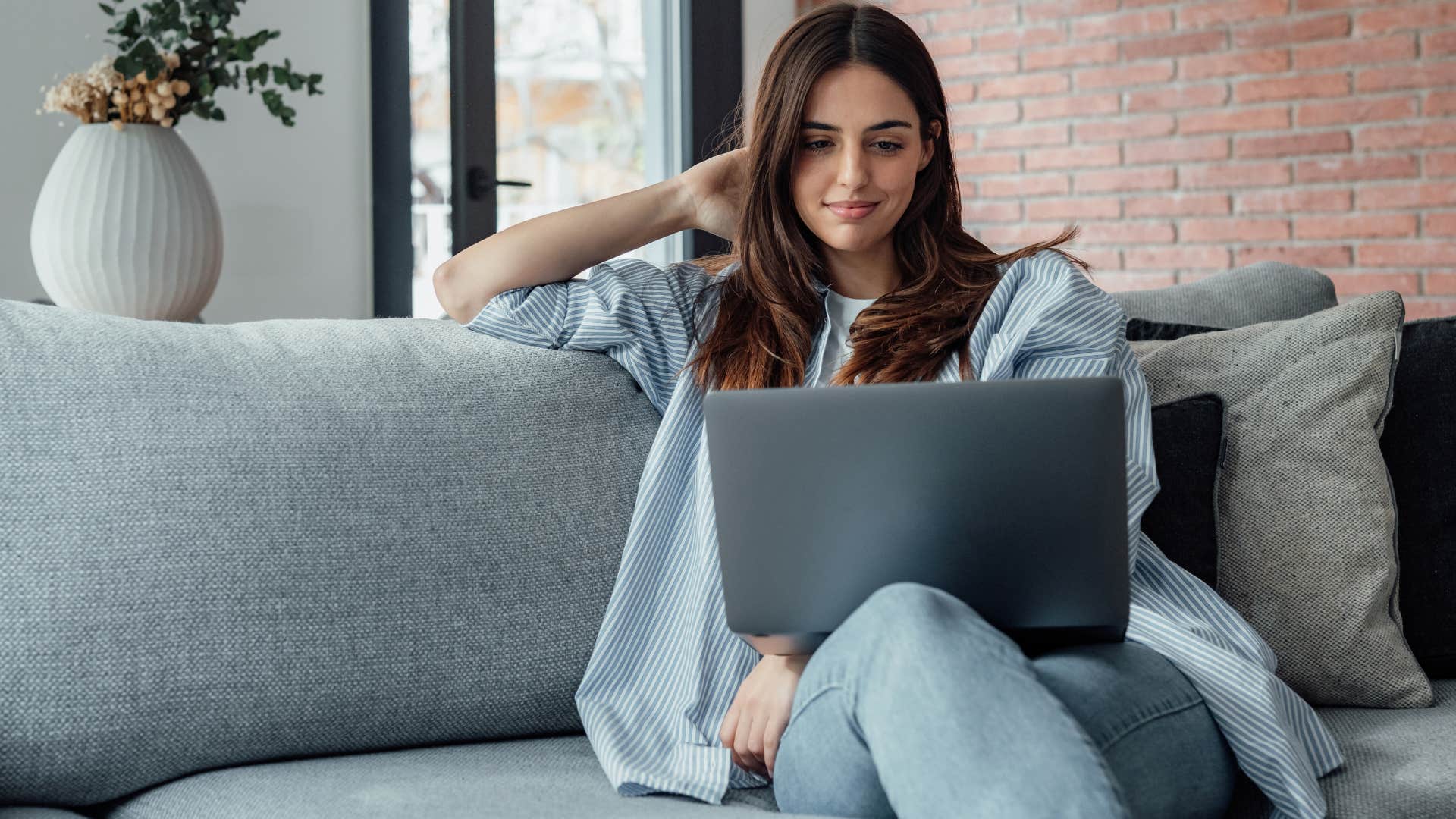 Woman sitting on decorative furniture in her living room.