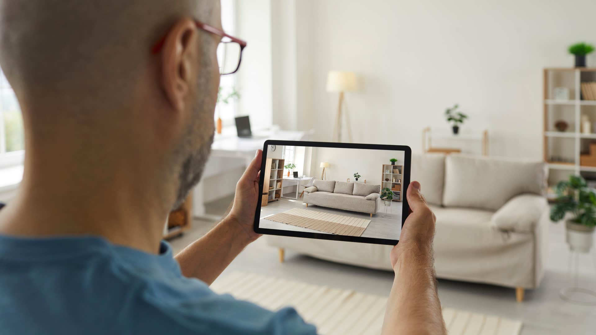 Man setting up intrusive technology in his living room.