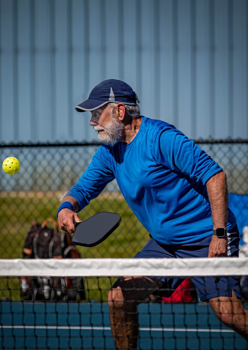 happy senior finding adventure playing pickleball