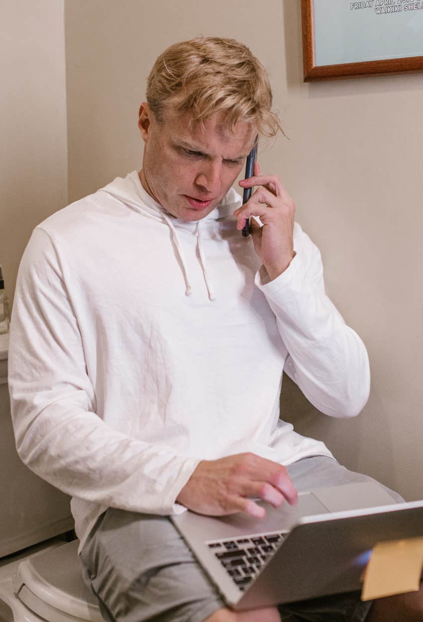 man taking a work meeting on the toilet
