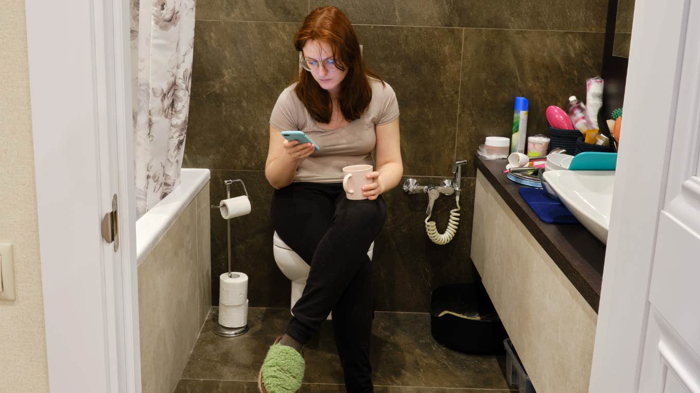 urvey Shows Americans Spend Over 4 Days Per Year Scrolling Social Media On The Toilet Woman scrolling social media on the toilet